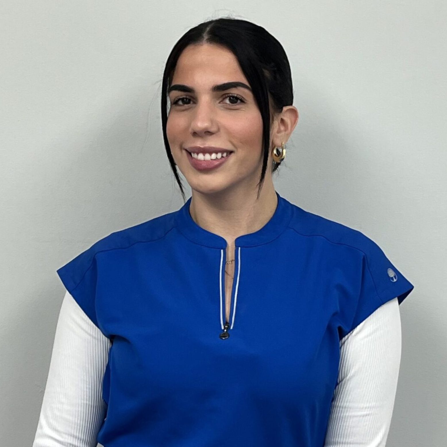 Young woman in royal blue scrub top