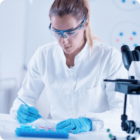 Scientist wearing goggles and gloves handling samples